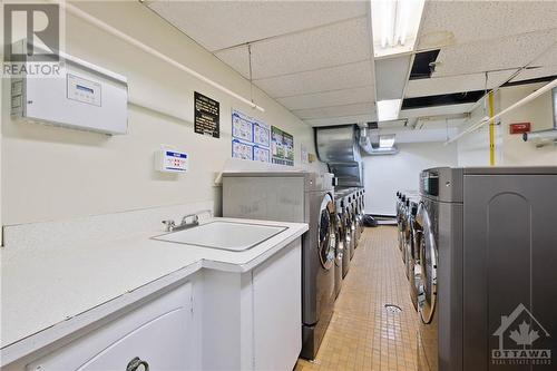 Laundry room with large washer and dryers. - 665 Bathgate Drive Unit#1401, Ottawa, ON - Indoor Photo Showing Laundry Room