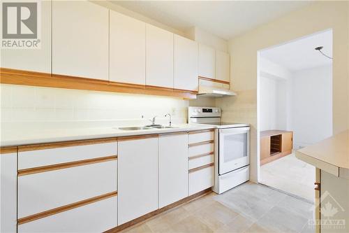 Kitchen convenient to Dining Room - 665 Bathgate Drive Unit#1401, Ottawa, ON - Indoor Photo Showing Kitchen With Double Sink