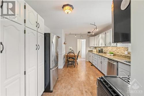 Chef's kitchen with granite countertop, plenty of cupboard space, gas stove and comfortable cork flooring - 10 Riverbrook Road, Ottawa, ON - Indoor