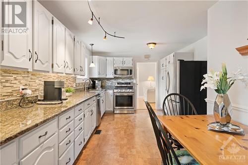 Chef's kitchen with granite countertop, plenty of cupboard space, gas stove and comfortable cork flooring - 10 Riverbrook Road, Ottawa, ON - Indoor Photo Showing Kitchen