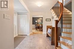 Front foyer with cherry banister and oak hardwood staircase to 2nd level - 