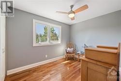 Bedroom 1: 8'8" x 11'1", featuring cherry hardwood flooring and ceiling fan - 