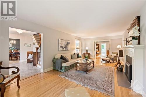 24'4" x 12' Living Room featuring oak hardwood flooring and gas fireplace with remote - 10 Riverbrook Road, Ottawa, ON - Indoor Photo Showing Living Room