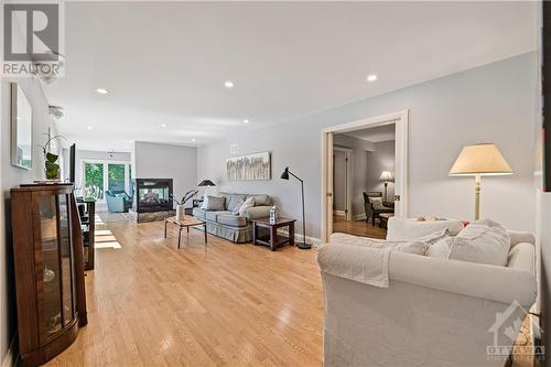 37'4" x 19' Family Room featuring oak hardwood flooring and a 3-Way Gas Fireplace with Remote - 10 Riverbrook Road, Ottawa, ON - Indoor Photo Showing Living Room