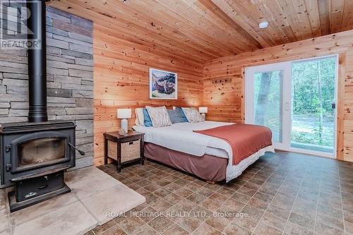 1306 -2 Eastshore Road, Georgian Bay, ON - Indoor Photo Showing Bedroom With Fireplace