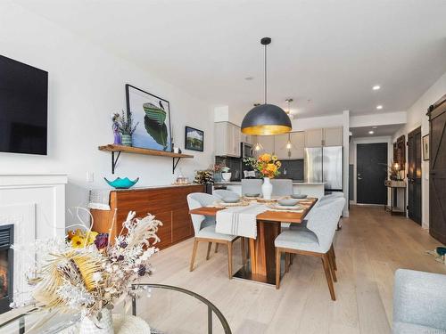 208-1035 Sutlej St, Victoria, BC - Indoor Photo Showing Dining Room With Fireplace