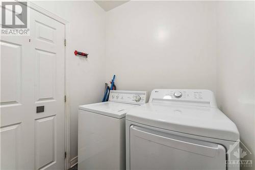 main floor powder room with washer and dryer - 1075 Normandy Crescent, Ottawa, ON - Indoor Photo Showing Laundry Room