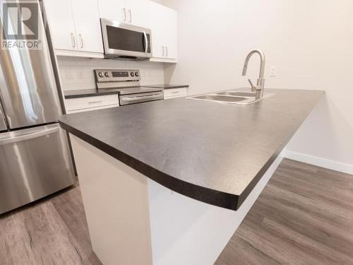 107-2009 Centennial Street, Whitehorse, YT - Indoor Photo Showing Kitchen With Stainless Steel Kitchen With Double Sink