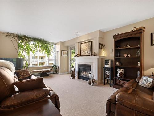 203-5685 Edgewater Lane, Nanaimo, BC - Indoor Photo Showing Living Room With Fireplace