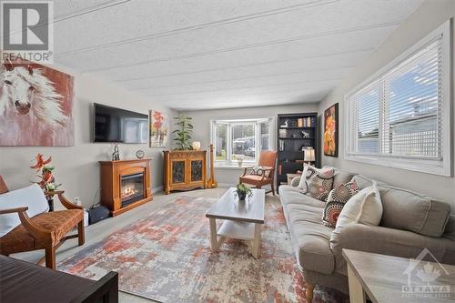 1029 Vista Barrett Private, Greely, ON - Indoor Photo Showing Living Room With Fireplace