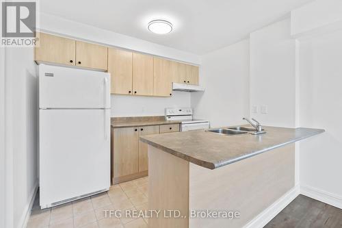 101 - 98 Aspen Springs Drive, Clarington (Bowmanville), ON - Indoor Photo Showing Kitchen With Double Sink