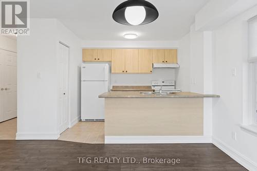 101 - 98 Aspen Springs Drive, Clarington (Bowmanville), ON - Indoor Photo Showing Kitchen With Double Sink