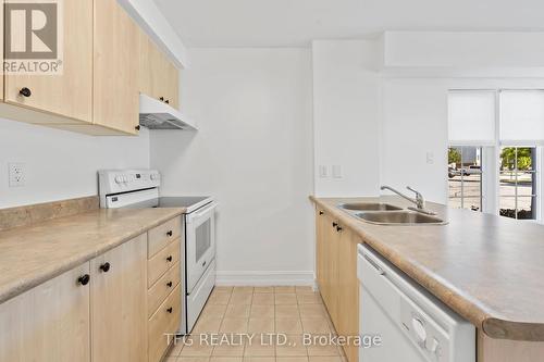 101 - 98 Aspen Springs Drive, Clarington (Bowmanville), ON - Indoor Photo Showing Kitchen With Double Sink