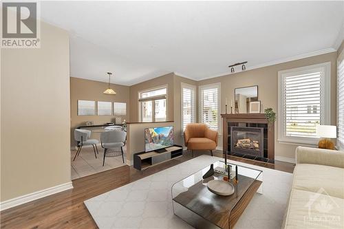 Living Room & eating area virtually staged - 779 Fletcher Circle, Ottawa, ON - Indoor Photo Showing Living Room With Fireplace