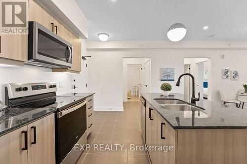 506 - 4 Spice Way, Barrie, ON - Indoor Photo Showing Kitchen With Stainless Steel Kitchen With Double Sink With Upgraded Kitchen