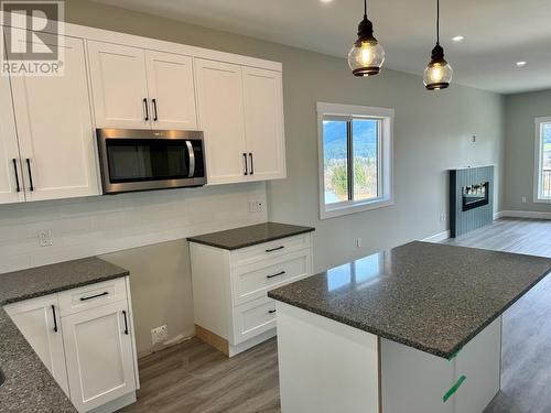 806 Cliff Avenue Unit# 107, Enderby, BC - Indoor Photo Showing Kitchen With Fireplace