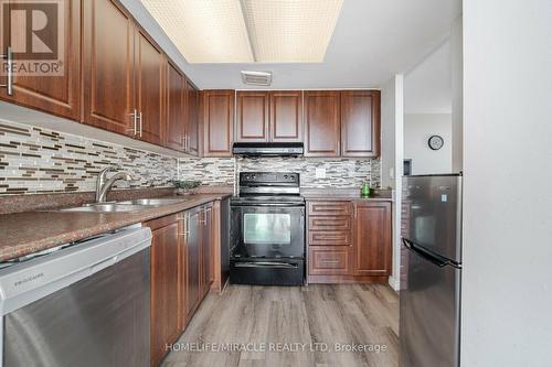 403 - 10 Markbrook Lane, Toronto (Mount Olive-Silverstone-Jamestown), ON - Indoor Photo Showing Kitchen With Double Sink