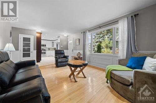 Look at how blue and inviting that pool is - 1605 Digby Street, Ottawa, ON - Indoor Photo Showing Living Room