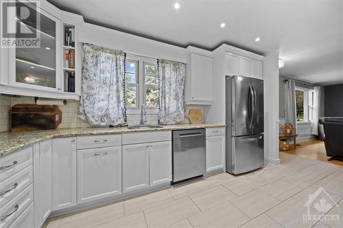 The living room is located right off the kitchen, making hosting a breeze - 1605 Digby Street, Ottawa, ON - Indoor Photo Showing Kitchen