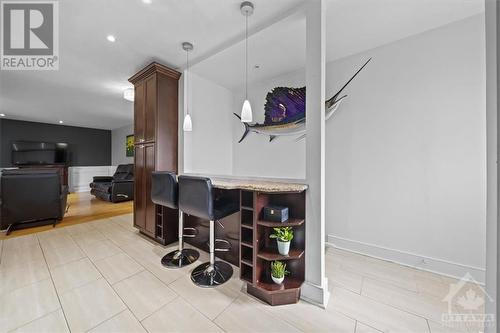 The upgraded kitchen is complete with a bar ledge, perfect for that moring coffee or a late night chat - 1605 Digby Street, Ottawa, ON - Indoor Photo Showing Other Room