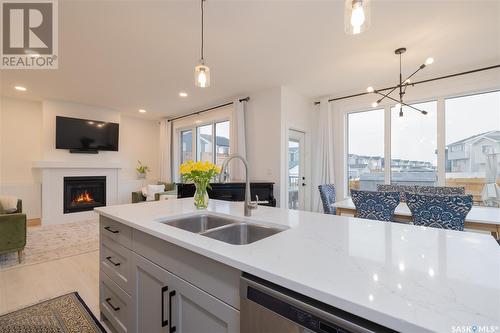 364 Olson Lane E, Saskatoon, SK - Indoor Photo Showing Kitchen With Fireplace With Double Sink