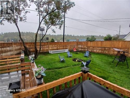 The deck overlooks the awesome yard. - 910 John Street, Mattawa, ON - Outdoor With Backyard