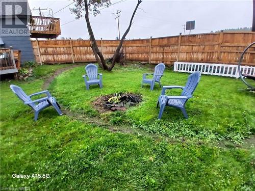 Chillax around your fire pit. - 910 John Street, Mattawa, ON - Outdoor With Backyard