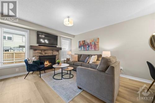 Cozy open concept main floor - 713 Mayfly Crescent, Ottawa, ON - Indoor Photo Showing Living Room With Fireplace