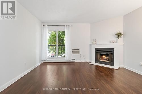 522 - 1450 Glen Abbey Gate, Oakville, ON - Indoor Photo Showing Living Room With Fireplace