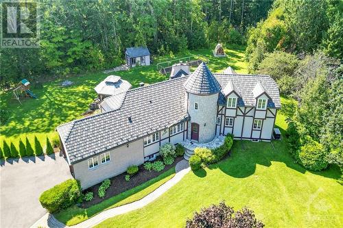 Nestled on a serene 2.38-acre lot in the coveted Maplewood Estates of Cumberland. With its distinctive stone entrance tower and thoughtfully designed floor plan, this home blends elegance with privacy - 1390 Millburn Crescent, Ottawa, ON - Outdoor