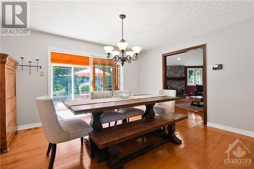 The adjoining formal dining room seamlessly connects to a solarium and back deck - 1390 Millburn Crescent, Ottawa, ON - Indoor Photo Showing Dining Room