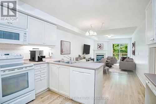 15 - 1735 The Collegeway, Mississauga, ON - Indoor Photo Showing Kitchen With Fireplace With Double Sink