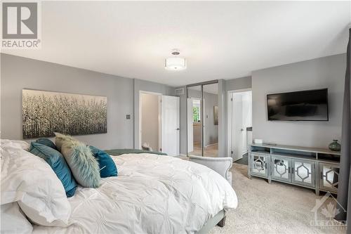 Walk in closet behind sliding mirror doors - 20 Spalding Avenue, Ottawa, ON - Indoor Photo Showing Bedroom