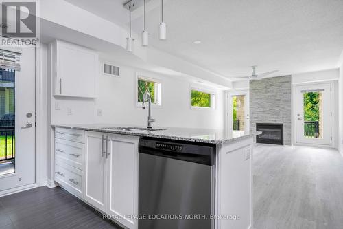 101 - 8 Brandy Lane Drive, Collingwood, ON - Indoor Photo Showing Kitchen With Fireplace