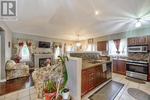 599 Fox Hollow Court, Woodstock, ON - Indoor Photo Showing Kitchen With Fireplace With Double Sink