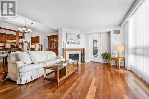 1402 - 2185 Marine Drive, Oakville, ON - Indoor Photo Showing Living Room With Fireplace