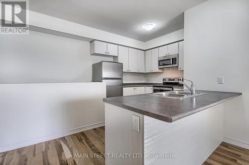 101 - 128 Barrie Street, Bradford West Gwillimbury, ON - Indoor Photo Showing Kitchen With Double Sink