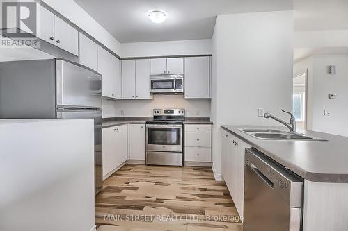 101 - 128 Barrie Street, Bradford West Gwillimbury, ON - Indoor Photo Showing Kitchen With Double Sink