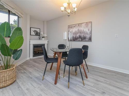 212-1745 Leighton Rd, Victoria, BC - Indoor Photo Showing Dining Room With Fireplace