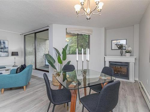 212-1745 Leighton Rd, Victoria, BC - Indoor Photo Showing Dining Room With Fireplace