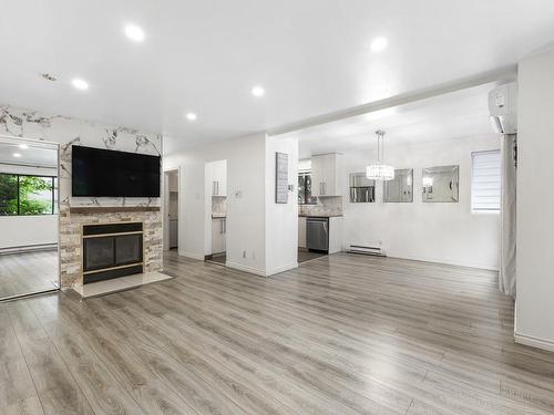 Salle familiale - 2-4410 Ch. Des Cageux, Laval (Chomedey), QC - Indoor Photo Showing Living Room With Fireplace