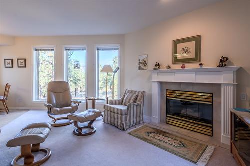 145-1634 Carmi Avenue, Penticton, BC - Indoor Photo Showing Living Room With Fireplace