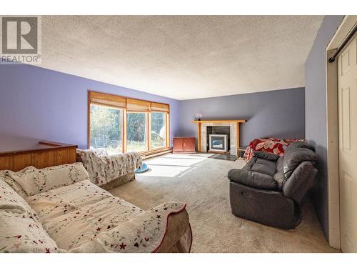 9905 6 Highway, Salmo, BC - Indoor Photo Showing Other Room With Fireplace