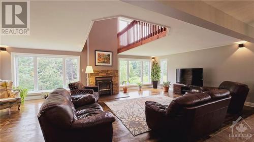 Primary Residence Living Room with wood-burning fireplace & refinished hardwood floors - 103 Lady Slipper Way, Carp, ON - Indoor Photo Showing Living Room With Fireplace