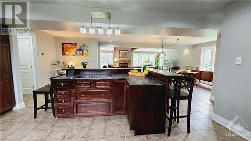 Island with built-in stove top and wrap-around bar for sitting - 103 Lady Slipper Way, Carp, ON - Indoor