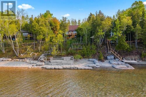 Stone crib break wall offers shoreline protection. - 139 Ivy Drive, Georgian Bluffs, ON - Outdoor With Body Of Water