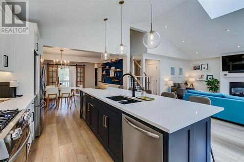 354 Mountain Park Drive Se, Calgary, AB - Indoor Photo Showing Kitchen With Fireplace With Double Sink With Upgraded Kitchen