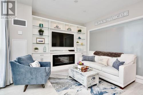 C404 - 301 Sea Ray Avenue, Innisfil, ON - Indoor Photo Showing Living Room With Fireplace