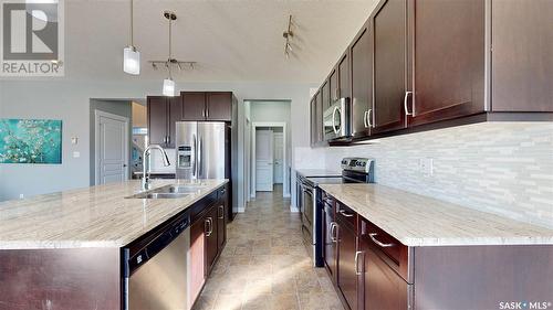 5331 Universal Crescent, Regina, SK - Indoor Photo Showing Kitchen With Stainless Steel Kitchen With Double Sink With Upgraded Kitchen