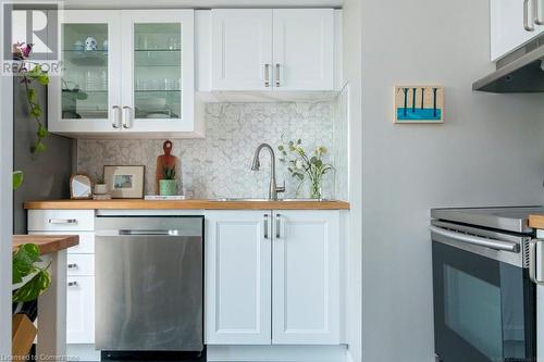 Modern and functional kitchen with timeless design. 2” Calcutta Grigio Hexagon  Matte Porcelain backsplash. - 4450 Tucana Court Unit# 1010, Mississauga, ON - Indoor Photo Showing Kitchen